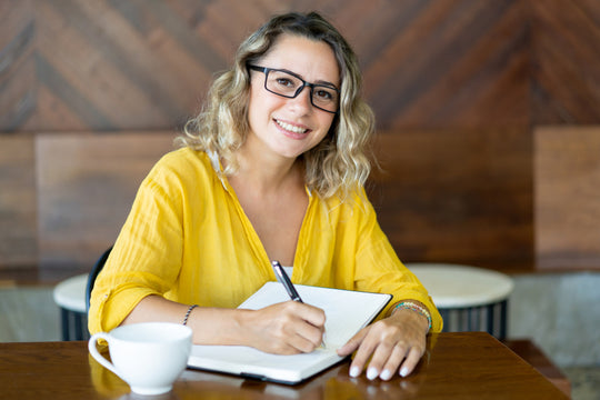woman writing on her planner organizing homework